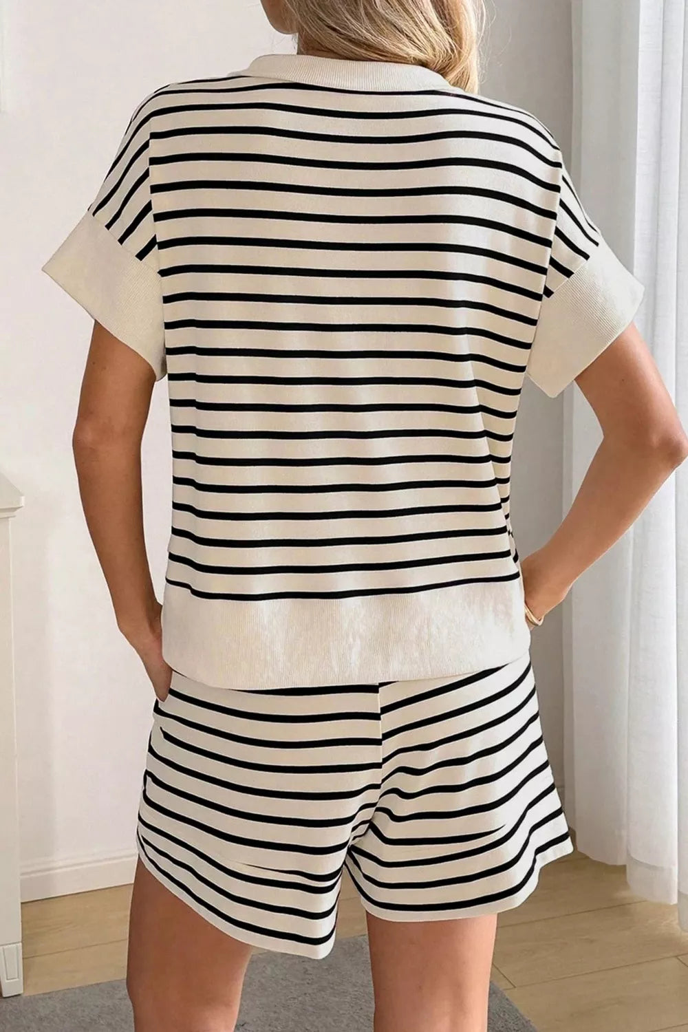 Classic striped half-zip two-piece set in beige and black cotton with short sleeves and shorts.