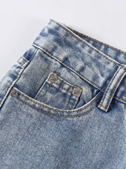 Light wash denim jeans with distressed details and shredded knee accents.