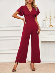 Burgundy flutter sleeve V-neck wide-leg jumpsuit with a fitted waist.