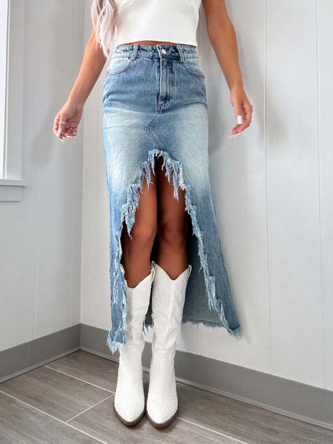 Light wash denim maxi skirt with distressed detailing and a high slit, cotton material