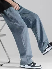 Men's loose fit light blue denim jeans with drawstring detail.