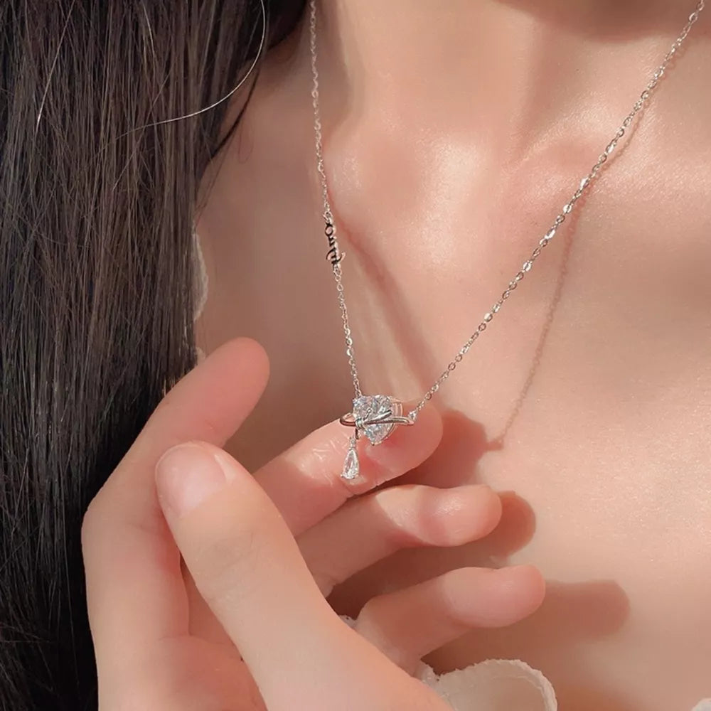 Elegant silver necklace with a zircon heart pendant and a teardrop charm.