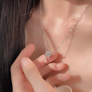Elegant silver necklace with a zircon heart pendant and a teardrop charm.