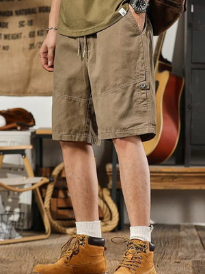 Men's taupe drawstring shorts with relaxed fit and buttoned cargo pocket.