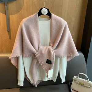Luxurious fuzzy triangle shawl scarf in dusty pink with fringe detail, styled over a white sweater.