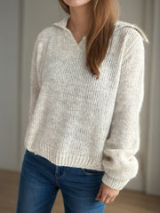 Textured knit polo sweater in beige with a V-neck and collar.