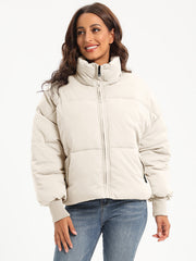Padded bomber jacket in cream with ribbed cuffs and a high collar.
