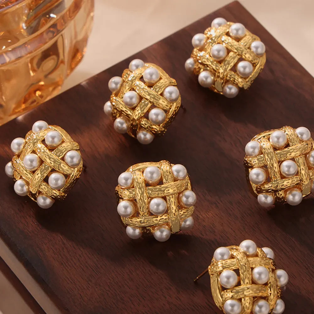 Gold woven pearl grid earrings with textured metal detail.