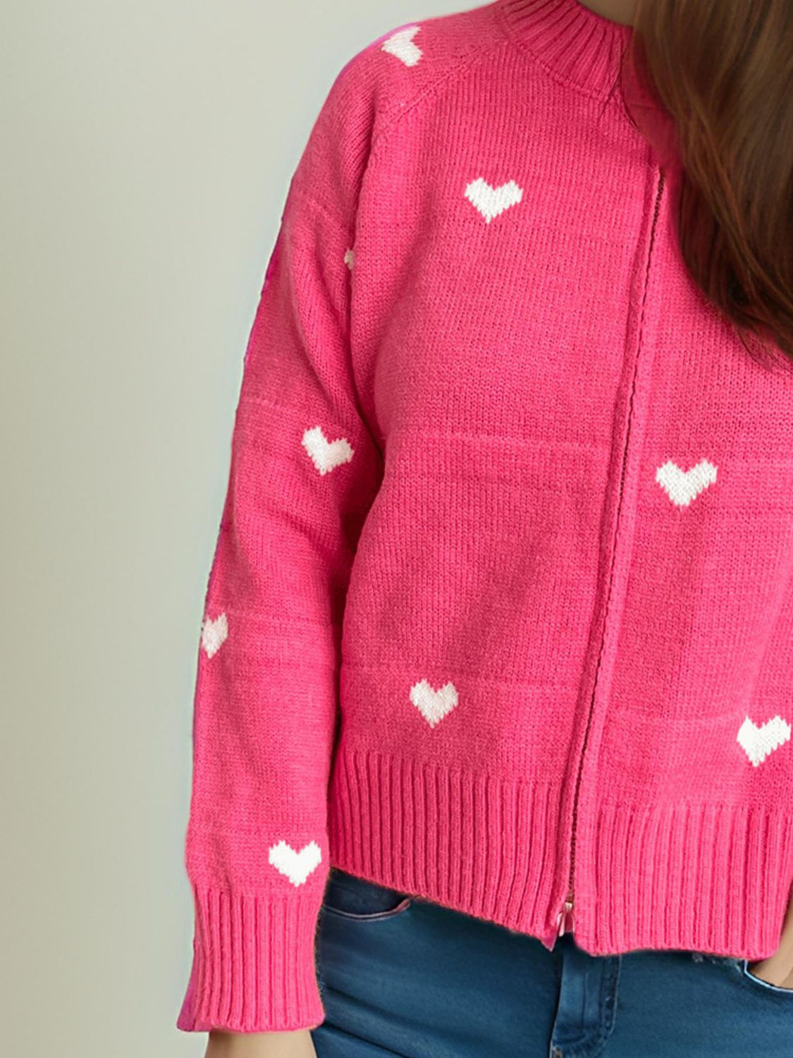 Hot Pink zip-through knit cardigan with white heart appliqué and ribbed cuffs and hem.
