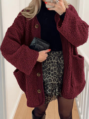 Burgundy teddy-texture button-up jacket with corduroy trim and pockets.
