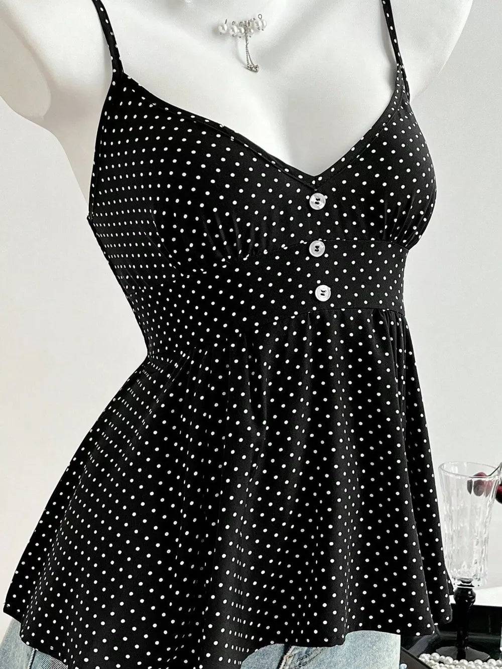 Black polka dot peplum cami with spaghetti straps and button detail
