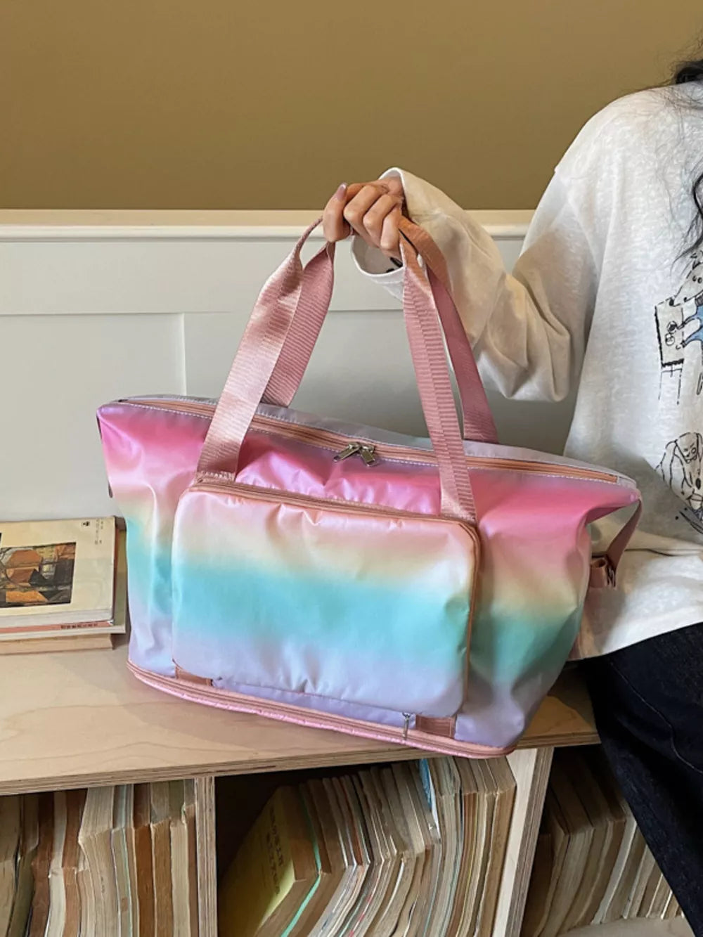 Iridescent gradient duffel bag with pink straps and front pocket