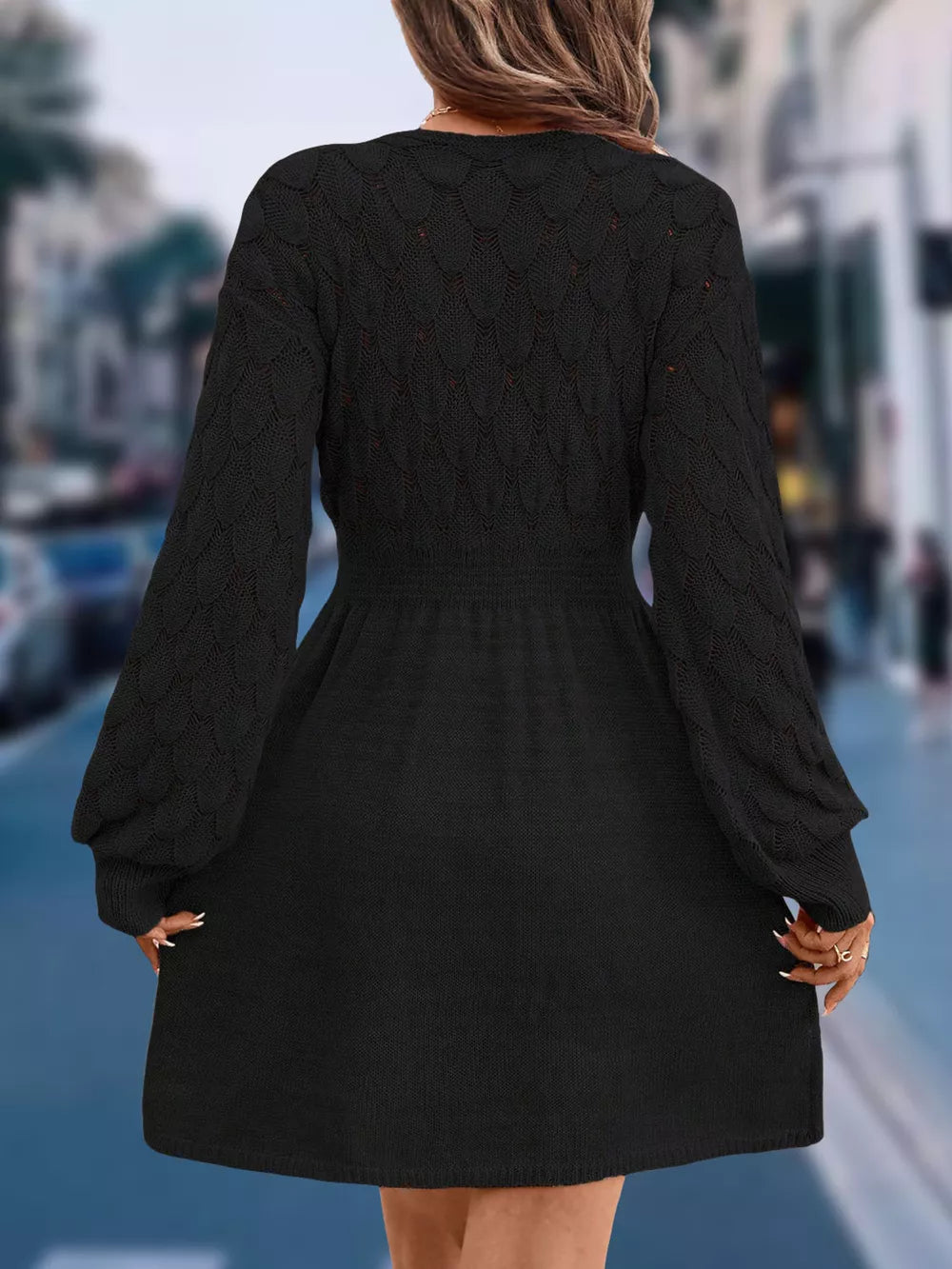 Black openwork knit V-neck sweater dress with cinched waist and above knee length.