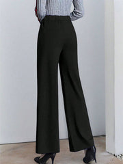 Black high-waisted wide leg cotton trousers with pockets, shown from the back.