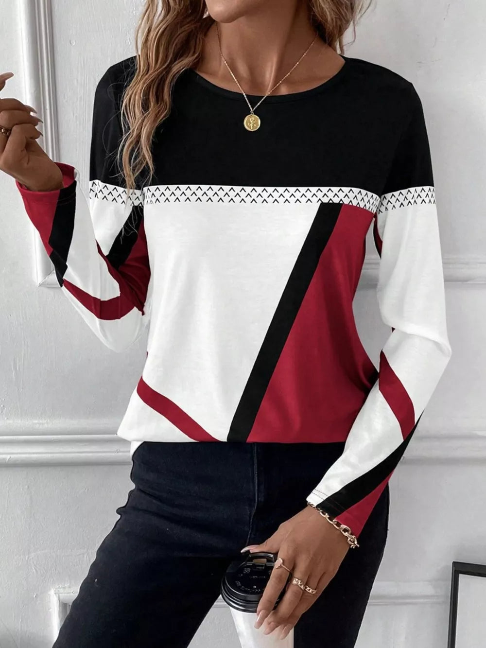 Geometric panel long sleeve t-shirt in black, white, and scarlet with chevron detail.
