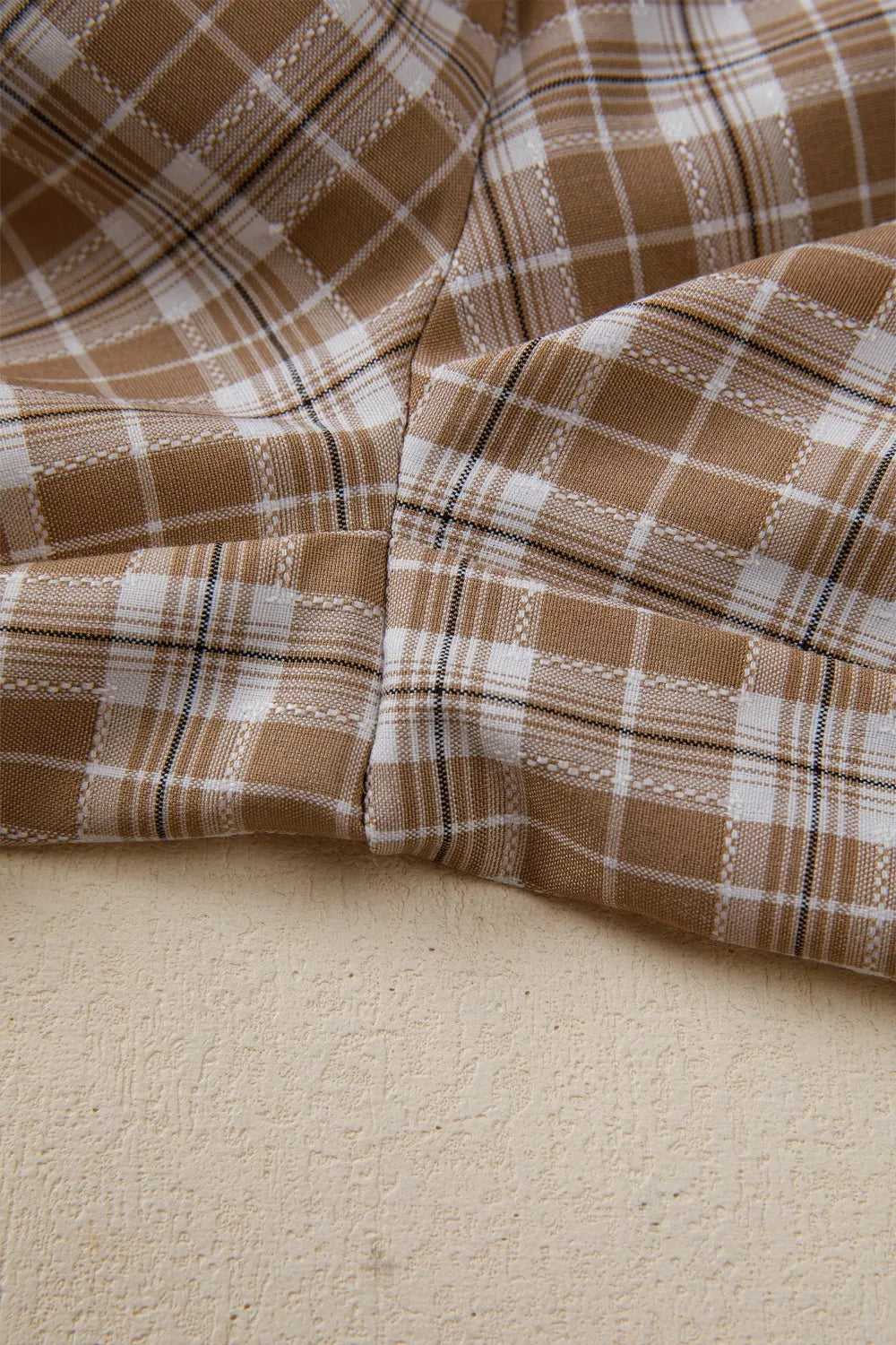 Plaid print casual pants in camel and white with drawstring detail.