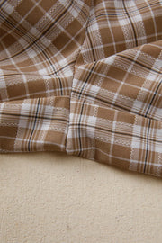 Plaid print casual pants in camel and white with drawstring detail.