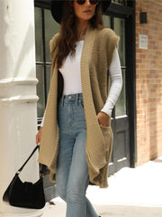Tan textured knit sleeveless cardigan vest with ribbed trim and pockets.
