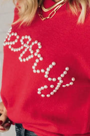 Red sweater with pearl embellished "Merry" text detail.