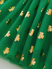 Green tulle dress with gold shamrock print and smocked detail.