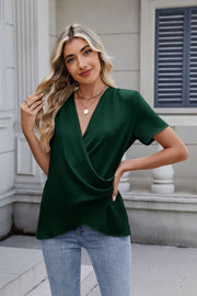 Dark green short sleeve blouse with draped front and V-neck.