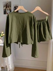 Army green cotton tie-front top with bell sleeves and matching drawstring shorts set.