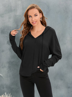 Black waffle knit relaxed fit hoodie with V-neck and drawstring.