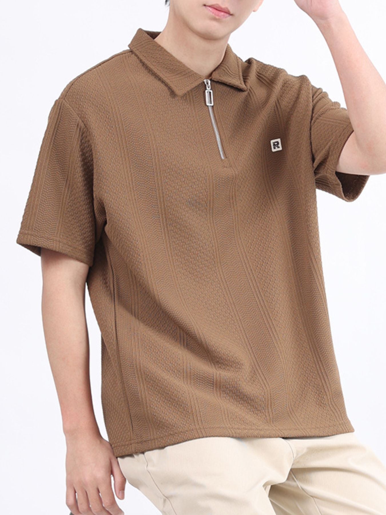Desert Color textured polo shirt with quarter zip and embroidered logo detail.