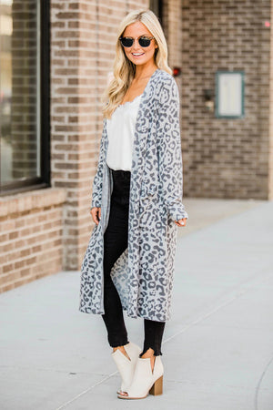 Duster cardigan in cloudy blue with leopard print, open front, and pockets.