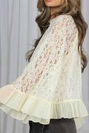 Cream floral lace maternity shirt with ruffled hem and sheer bell sleeves.