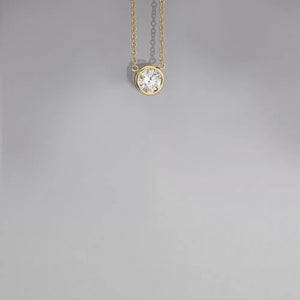18K gold-plated necklace with a bezel-set diamond solitaire pendant.