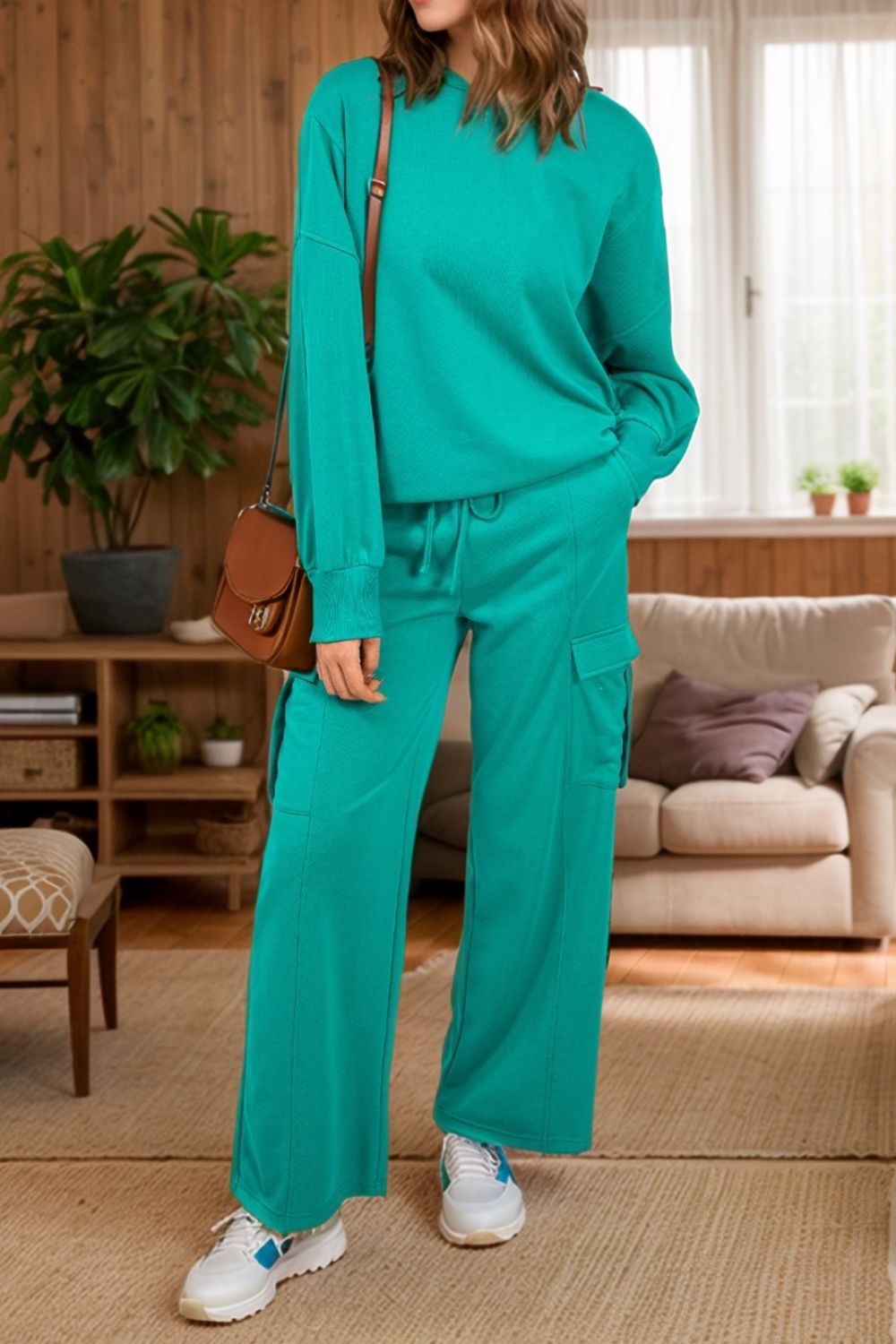 Turquoise relaxed fit lounge set with cargo pockets, crew neck sweatshirt and drawstring pants.