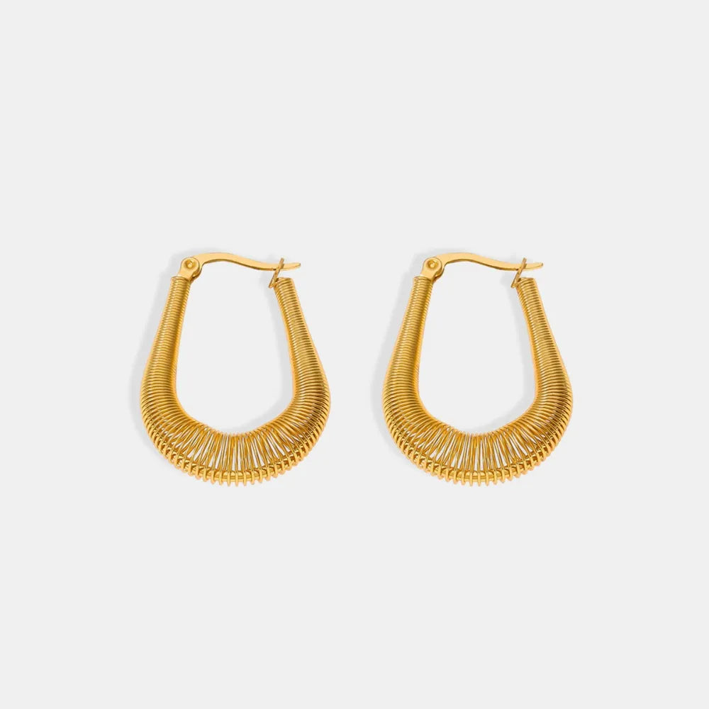 Gold coiled oval hoop earrings with a textured wire design.