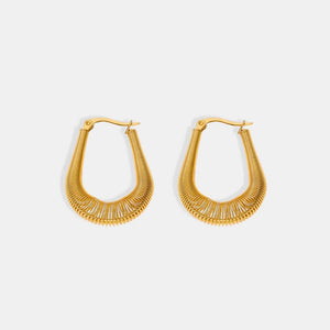 Gold coiled oval hoop earrings with a textured wire design.