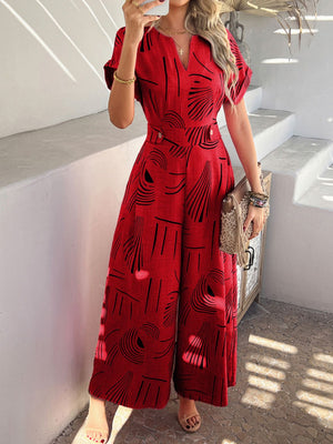 Scarlet geometric print wide-leg jumpsuit with V-neck and short sleeves.