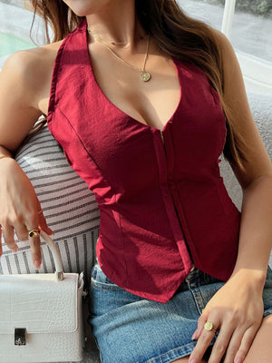 Burgundy halter corset top with a deep V-neck and front zipper detail.