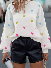 White knit sweater with colorful heart pattern, crew neck, and balloon sleeves.
