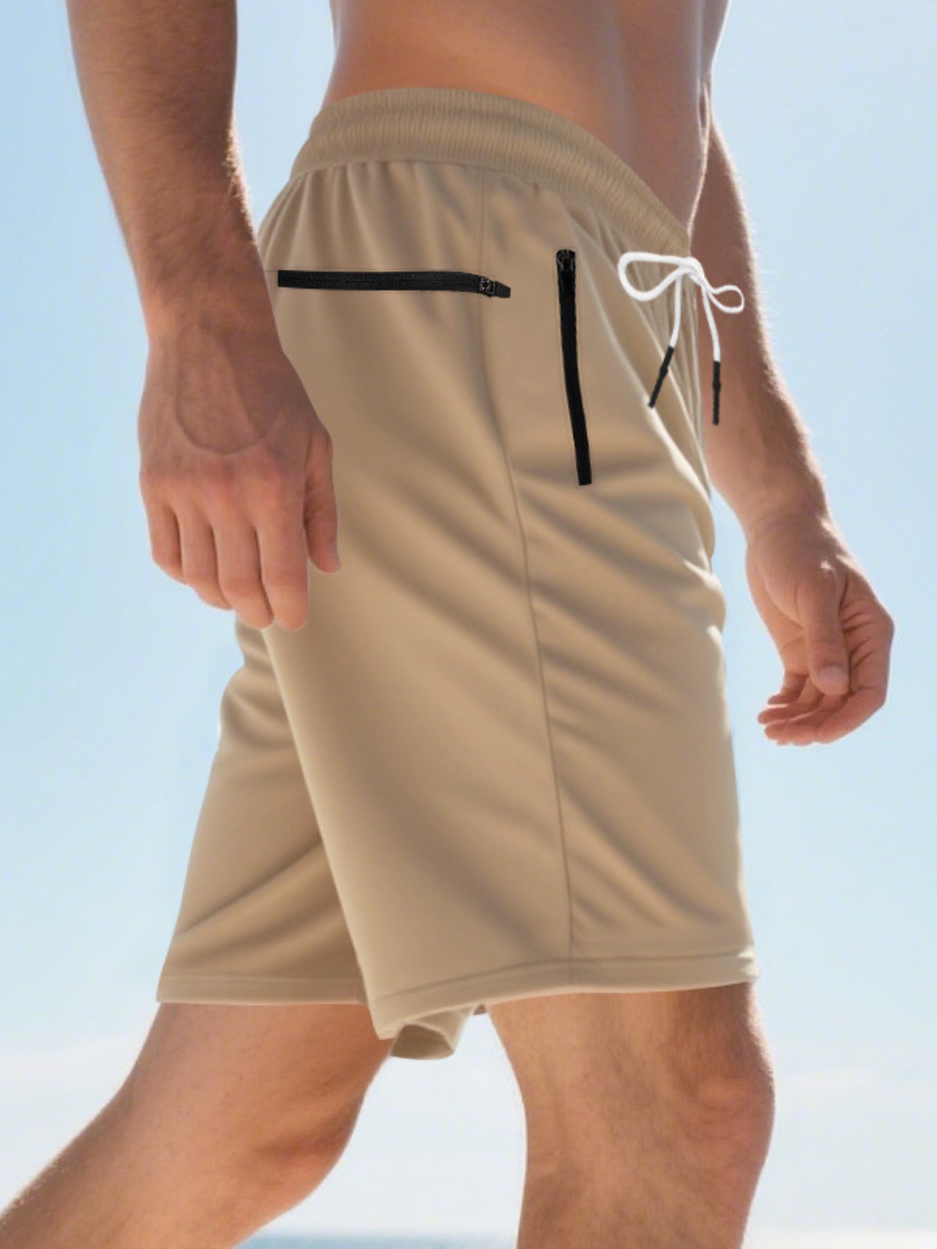Khaki chino shorts for men with drawstring and black zip pockets.