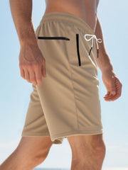 Khaki chino shorts for men with drawstring and black zip pockets.