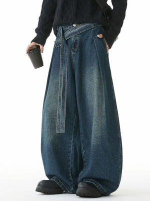 Belted relaxed fit men's jeans in vintage blue denim with a wide leg and tie waist.