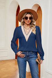 Navy blue knit v-neck blouse with lace sleeves and ruffled cuffs.