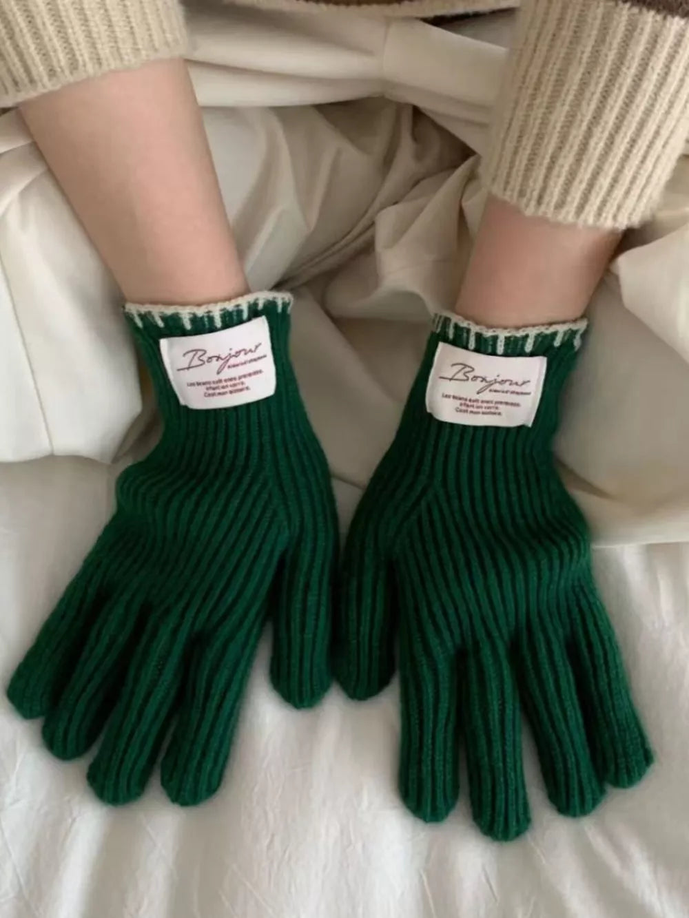 Dark green ribbed knit gloves with scalloped cream cuff and Bonjour label.