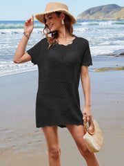 Black crochet beach cover-up dress with scalloped hem and short sleeves.