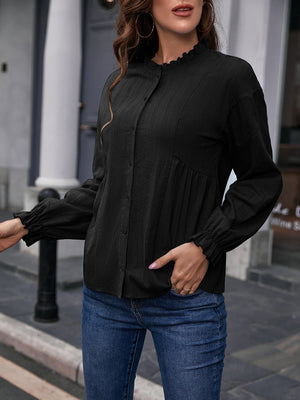 Black textured peplum blouse with ruffle collar and cuffs, button front, long sleeves.