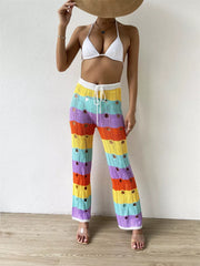 Vibrant crochet knit pants with rainbow stripes and cutout details.