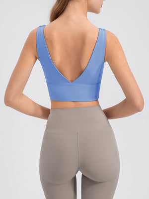 Light blue backless performance crop top with V-neck and tie shoulder detail