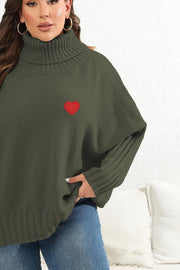 Army green knit turtleneck sweater with red heart appliqué and batwing sleeves.