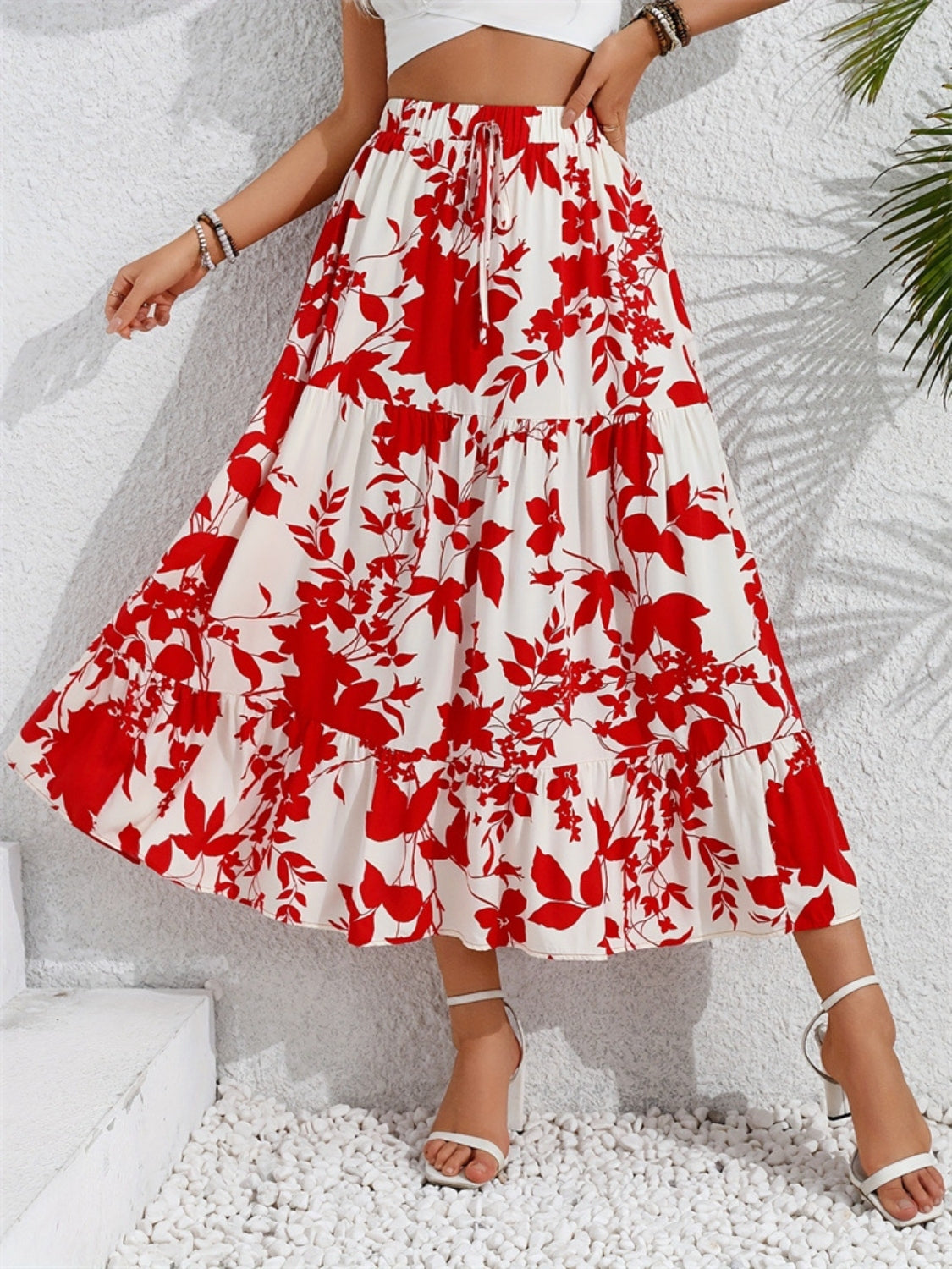 Crimson floral tiered midi skirt with a drawstring waist and ruffled hem.