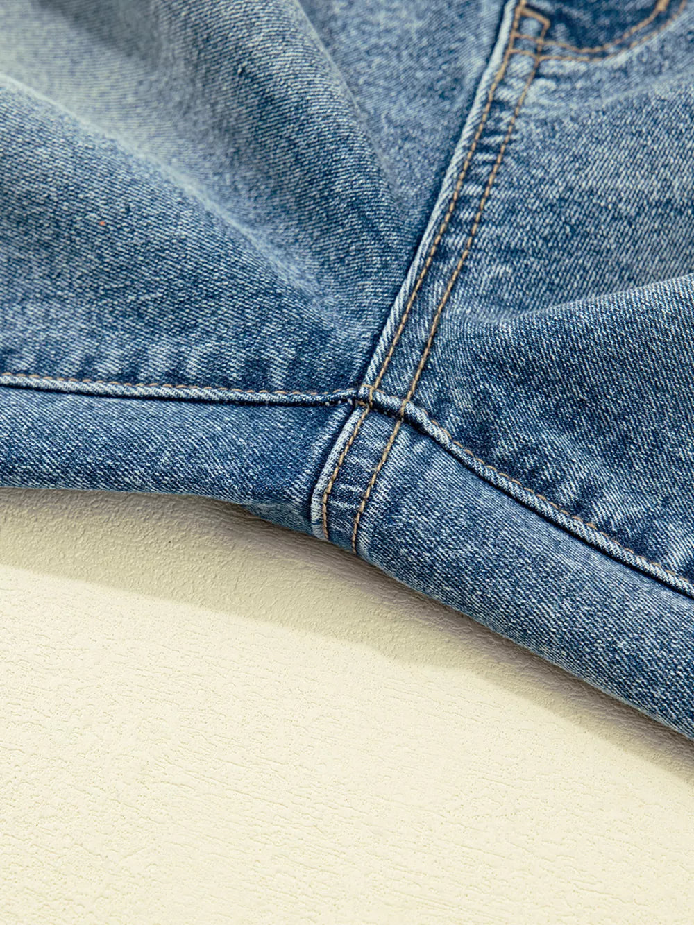 Vintage-inspired high-waisted maternity jeans in blue denim, showing seam detail