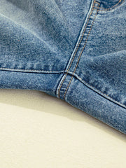 Vintage-inspired high-waisted maternity jeans in blue denim, showing seam detail